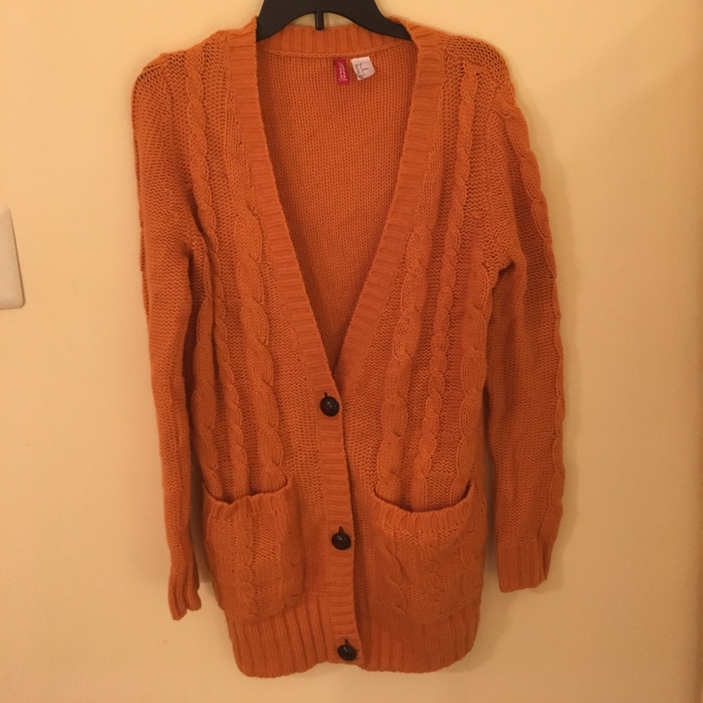 Adorable orange sweater.